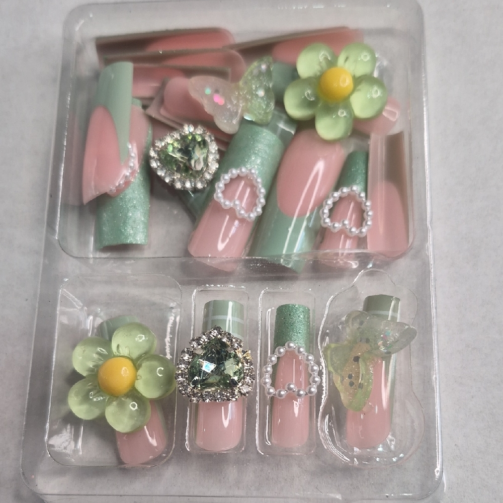 Chic Press-on Nails in Nude Base Color and Green French Tips w/ Accent Charms.